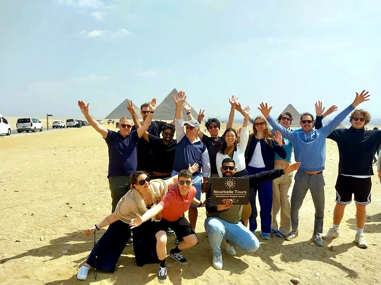 Nourbelle partner group waving at the Giza Pyramids